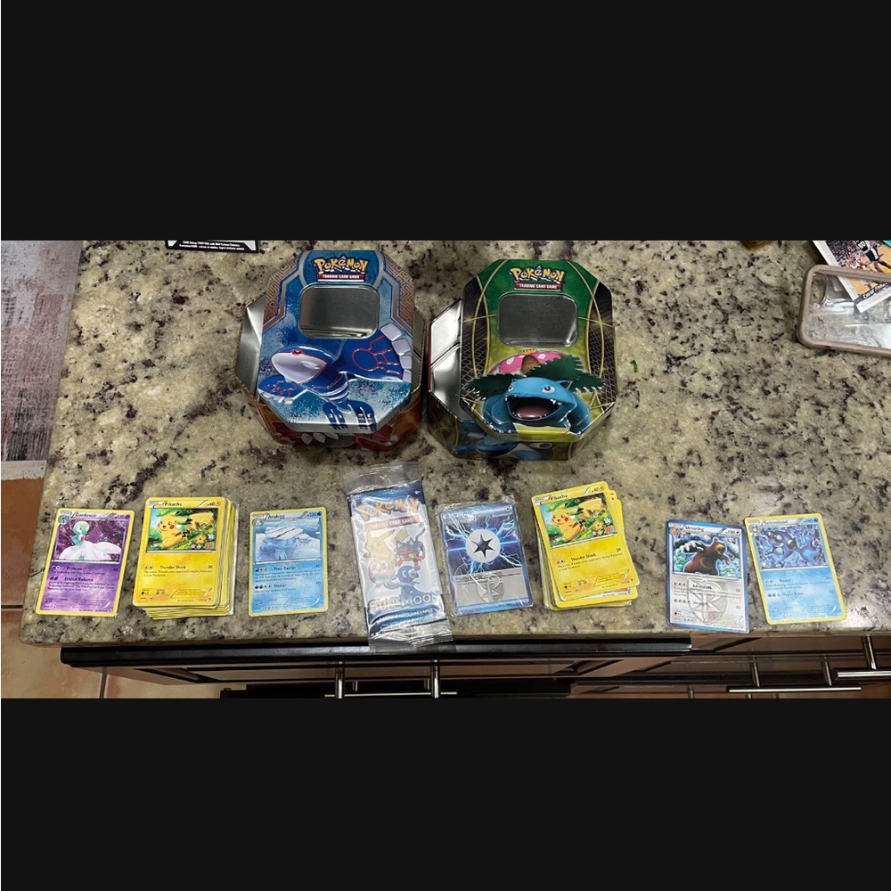 2 tins of Pokemon cards
